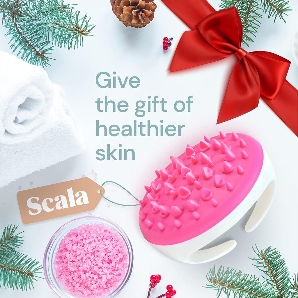 a pink and white massage brush with pine branches and a red bow with text: 'Give the gift of healthier skin Scala'