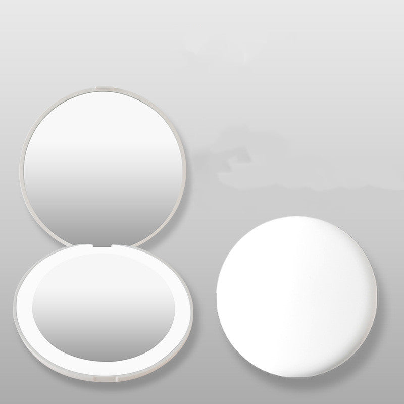 a white compact mirror with a mirror on it