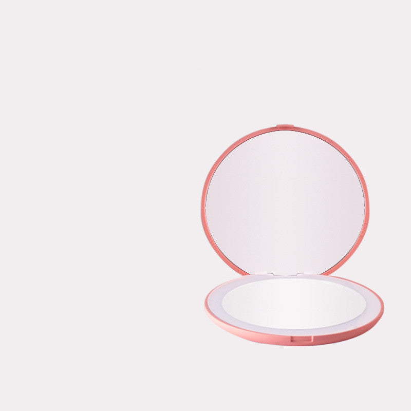 a pink and white compact mirror