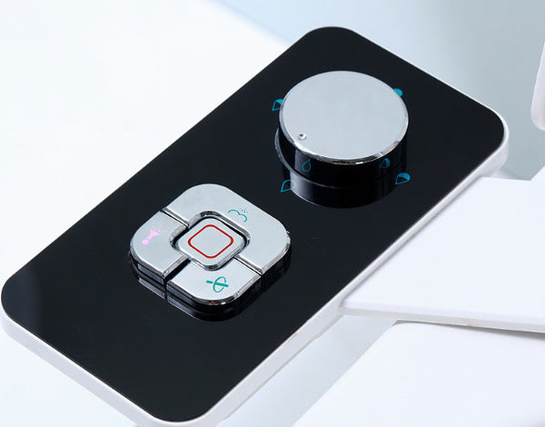 a black and silver device with a round button with text: '-A'