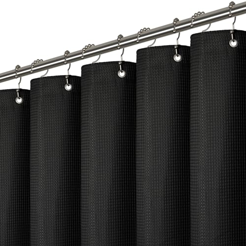 a black curtain with rings on a metal rod