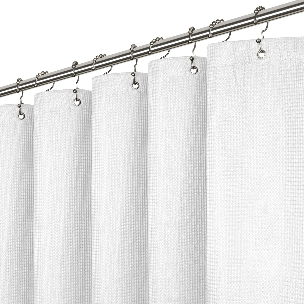 a white curtain with metal rings